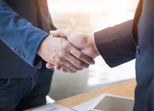 Two confident business man shaking hands during a meeting in the office, success, dealing, greeting and partner concept
